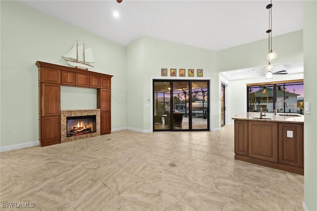 2405 Cherimoya Ln, Saint James City, FL 33956 - living room featuring a warm lit fireplace, a ceiling fan, and light marble finish floors