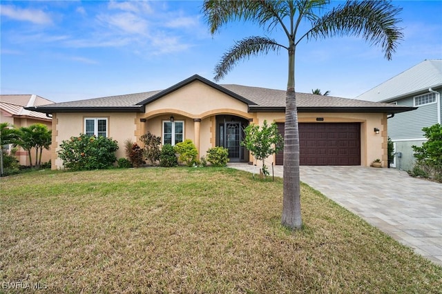 2405 Cherimoya Ln, Saint James City, FL 33956 - ranch-style house featuring stucco siding, a garage, decorative driveway, and a front yard