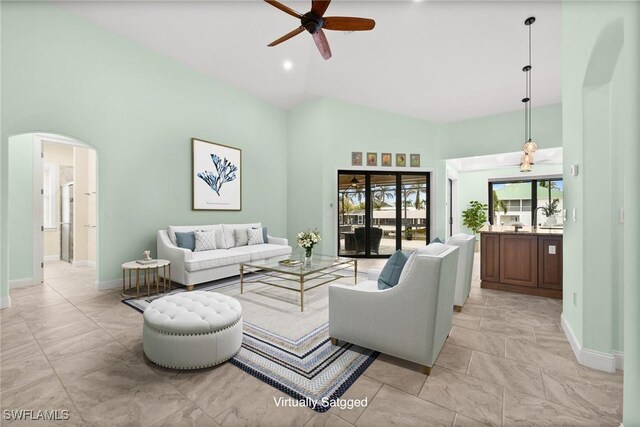2405 Cherimoya Ln, Saint James City, FL 33956 - living area featuring a ceiling fan, arched walkways, and high vaulted ceiling
