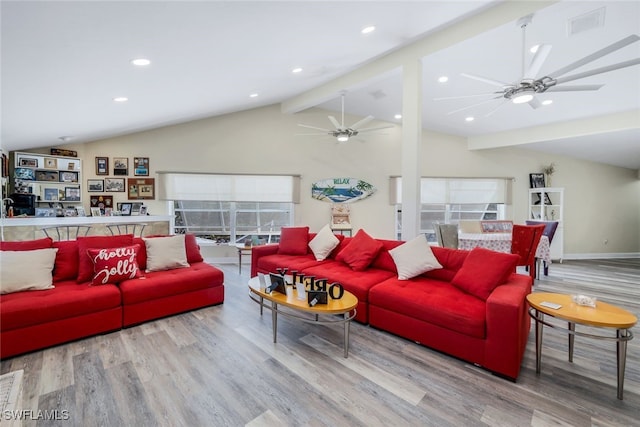 living room featuring wood-type flooring, vaulted ceiling with beams, and a healthy amount of sunlight