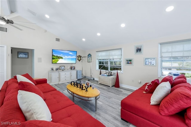 living room with ceiling fan, high vaulted ceiling, and light wood-type flooring