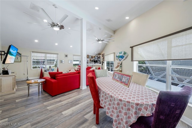 dining room with beam ceiling, hardwood / wood-style flooring, high vaulted ceiling, and ceiling fan