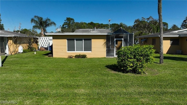 rear view of house with a lawn