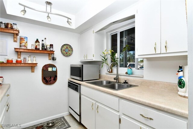 kitchen with white cabinetry, sink, and white dishwasher