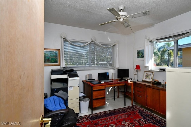 office with ceiling fan and a textured ceiling