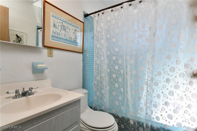 full bathroom featuring shower / tub combo, vanity, and toilet