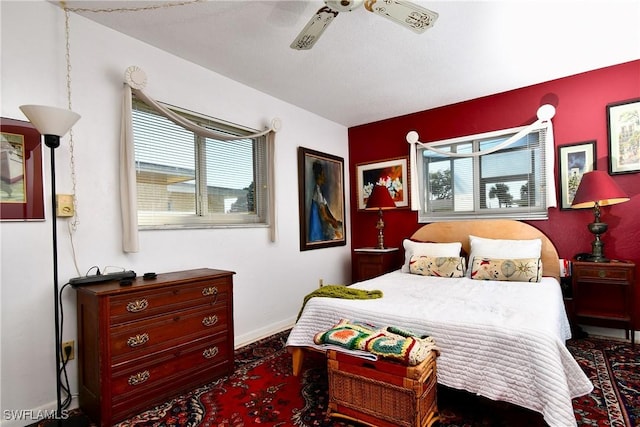 bedroom featuring ceiling fan and multiple windows