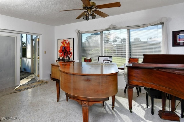 interior space with a textured ceiling, plenty of natural light, and ceiling fan