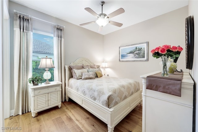 bedroom with light hardwood / wood-style floors and ceiling fan