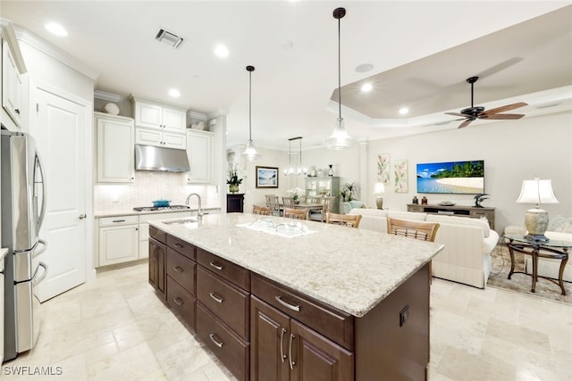 kitchen featuring white cabinets, ceiling fan, dark brown cabinetry, and appliances with stainless steel finishes