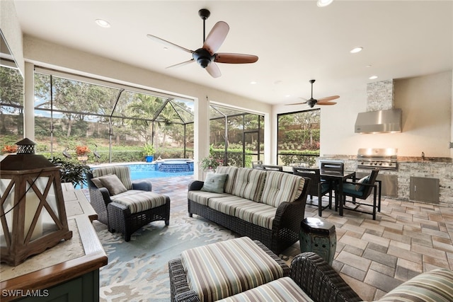 sunroom / solarium featuring ceiling fan