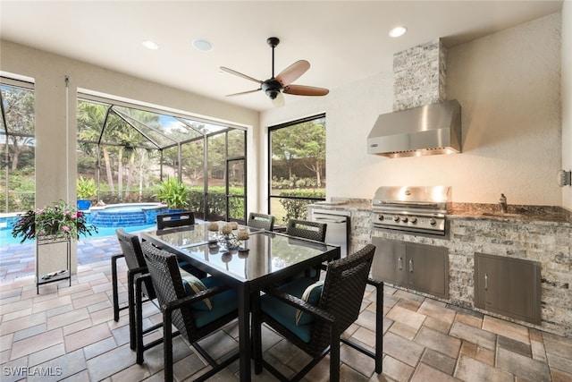 view of patio with a lanai, a grill, area for grilling, and a pool with hot tub