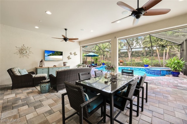 view of patio / terrace with a swimming pool with hot tub