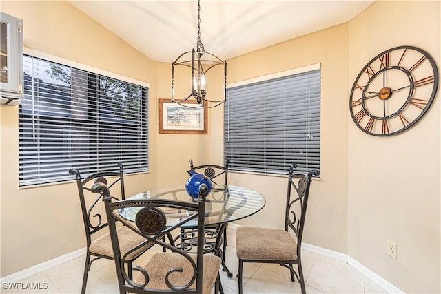 dining room with light tile patterned flooring and a notable chandelier