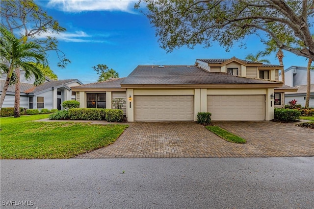 27062 Kindlewood Ln, Bonita Springs, FL 34134 - view of front facade featuring a tiled roof, decorative driveway, stucco siding, a front yard, and a garage