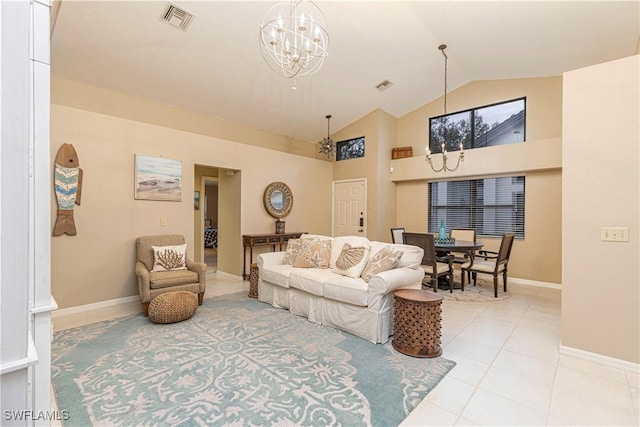 living room with lofted ceiling, light tile patterned floors, and a chandelier