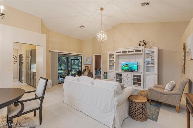 living room featuring high vaulted ceiling and a chandelier