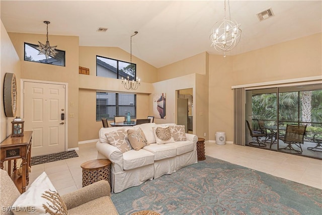 living room with light tile patterned floors, high vaulted ceiling, and a notable chandelier