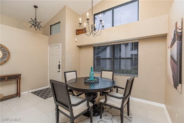 dining area with high vaulted ceiling, light tile patterned flooring, and an inviting chandelier