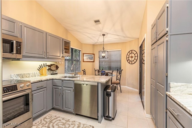 kitchen featuring gray cabinetry, pendant lighting, vaulted ceiling, kitchen peninsula, and stainless steel appliances