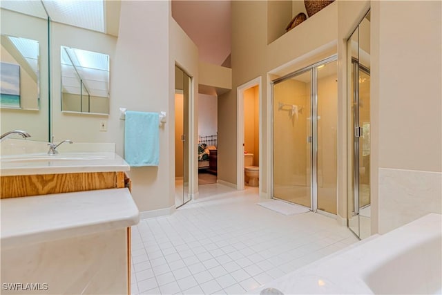 bathroom with tile patterned flooring, vanity, toilet, and a shower with shower door