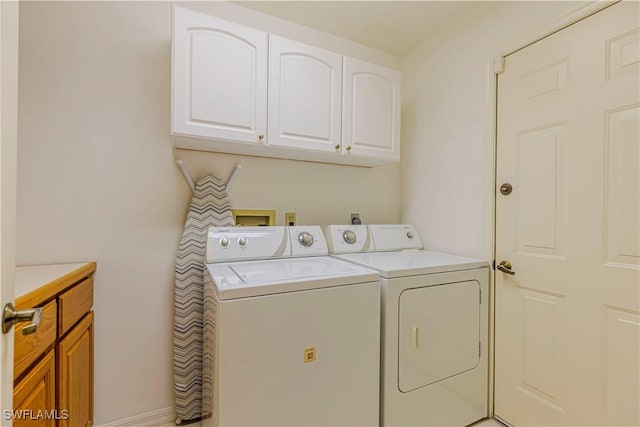 laundry area with cabinets and washing machine and dryer