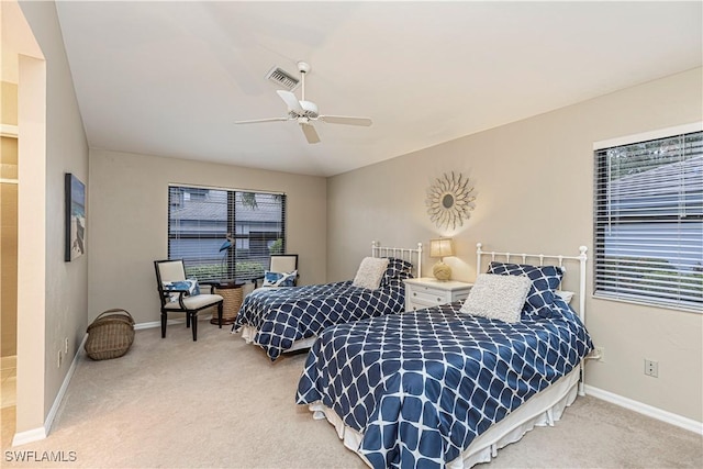 bedroom with ceiling fan and light colored carpet