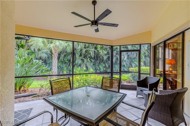 sunroom featuring ceiling fan and lofted ceiling