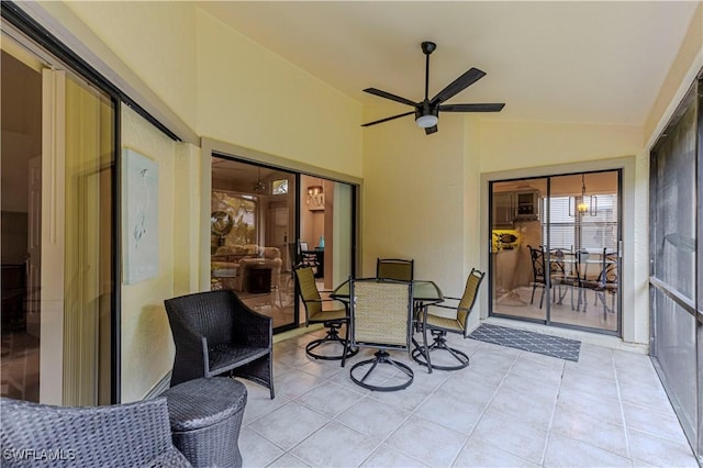 sunroom / solarium featuring ceiling fan and lofted ceiling