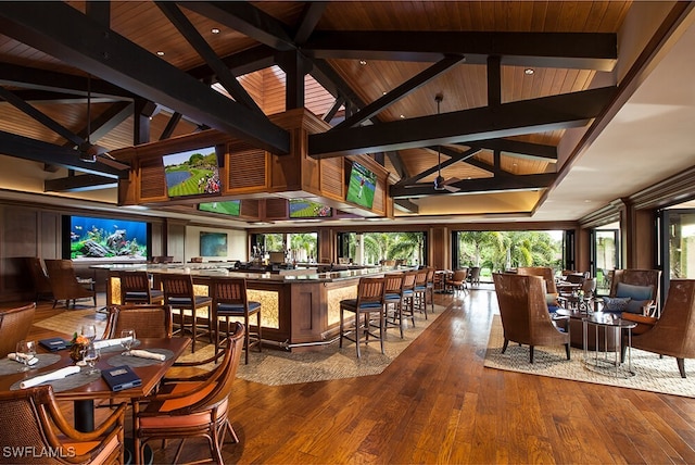 bar featuring hardwood / wood-style flooring, wooden ceiling, beamed ceiling, and high vaulted ceiling