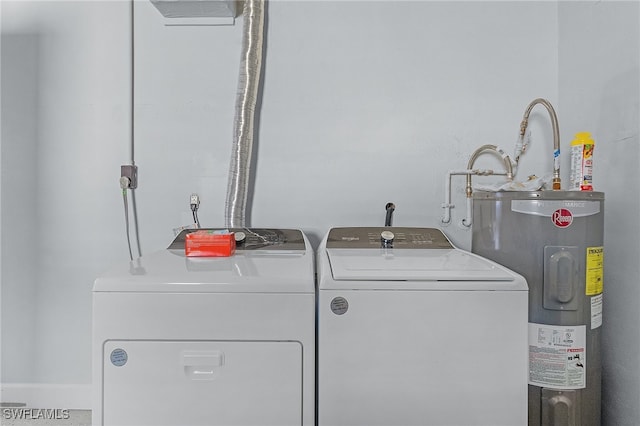 clothes washing area with separate washer and dryer and water heater