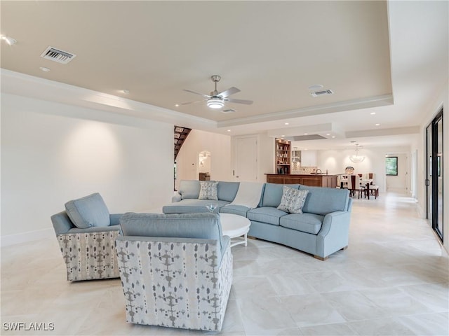 living room featuring visible vents, a tray ceiling, and recessed lighting