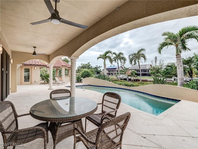 outdoor pool featuring a patio area and ceiling fan