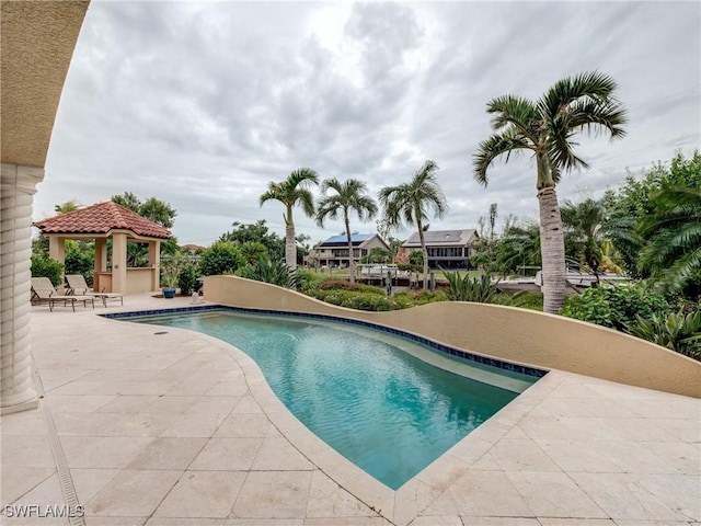 outdoor pool with a gazebo and a patio