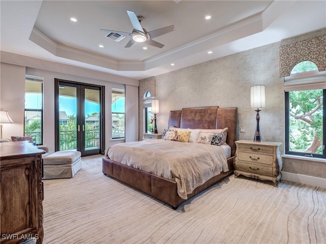 bedroom with a tray ceiling, french doors, recessed lighting, visible vents, and access to outside