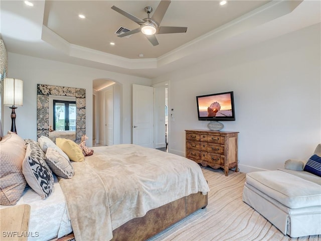 bedroom with arched walkways, recessed lighting, visible vents, baseboards, and a raised ceiling