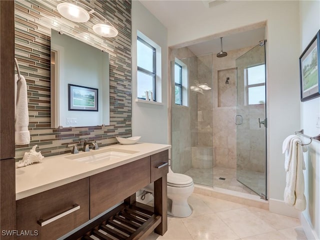 full bathroom with toilet, decorative backsplash, a stall shower, vanity, and tile patterned floors