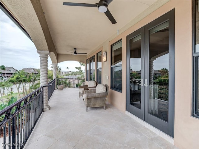 view of patio / terrace with a balcony and a ceiling fan