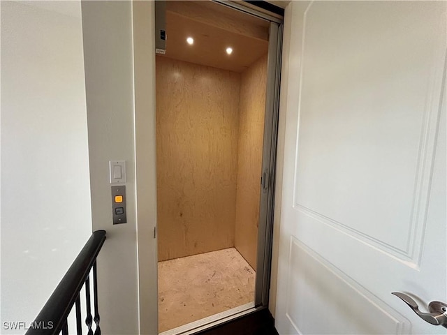 interior details featuring elevator and recessed lighting