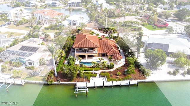 birds eye view of property with a water view and a residential view