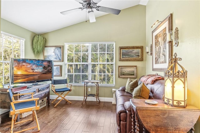 sitting room with ceiling fan, a wealth of natural light, lofted ceiling, and wood-type flooring