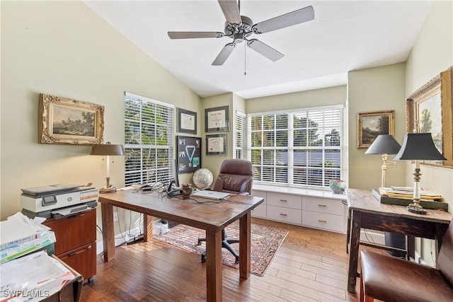 office space featuring ceiling fan, lofted ceiling, and hardwood / wood-style flooring