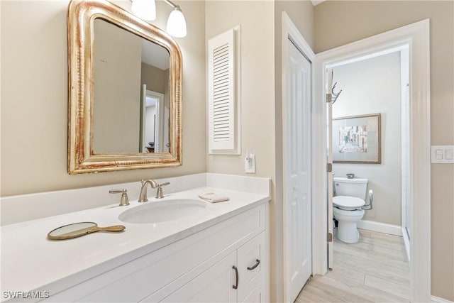 bathroom featuring toilet and vanity