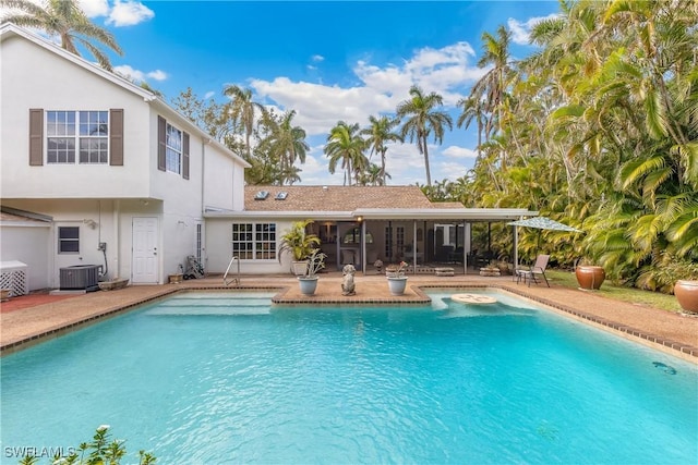 view of pool featuring central AC and a patio