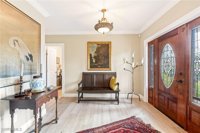 foyer entrance with crown molding and light hardwood / wood-style floors