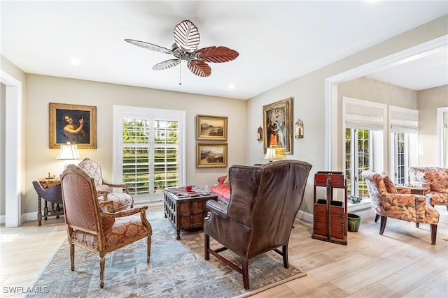 living area featuring ceiling fan and light hardwood / wood-style floors