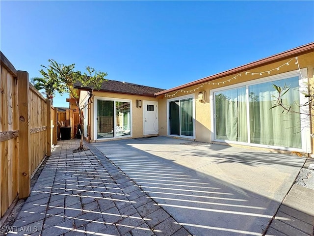 rear view of property featuring a patio area