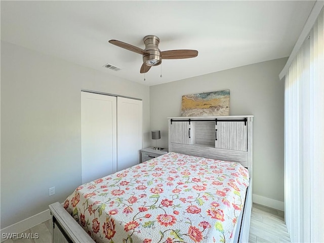 bedroom with ceiling fan and a closet