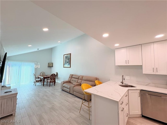 6342 Royal Woods Dr, Fort Myers, FL 33908 - kitchen with a sink, light stone countertops, dishwasher, lofted ceiling, and white cabinets