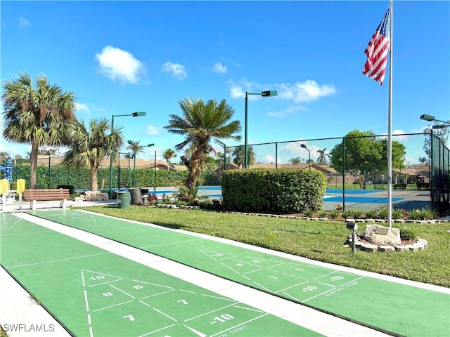 6342 Royal Woods Dr, Fort Myers, FL 33908 - surrounding community with a lawn, fence, and shuffleboard